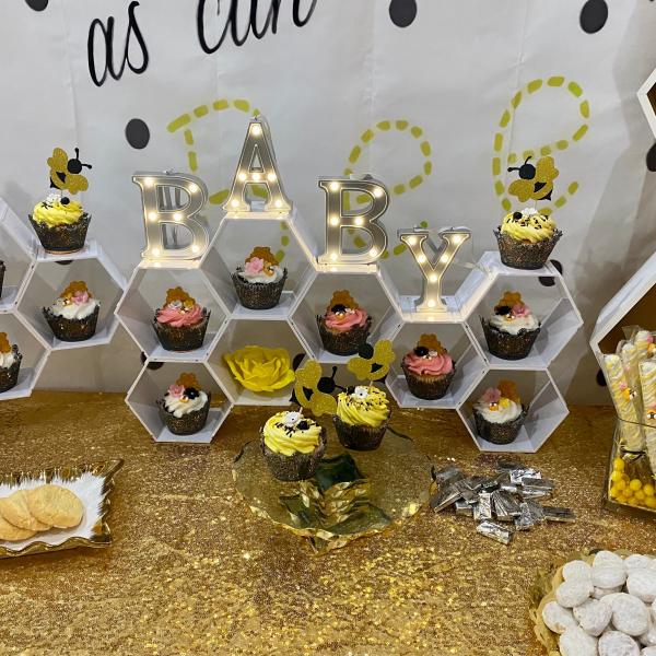 Sweet as can Bee dessert table with cup cakes, cake pops and chocolate covered pretzels