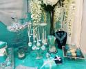 Dessert table decor for the Tiffany & Co. sweet 16 birthday party. White florals in a black glass vase, jewels, pearls and Tiffany boxes were just a few of the decorations used for this tablescape