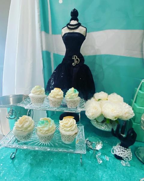 Cake pops, cupcakes, macarons, chocolate kisses, chocolate covered pretzels and the Tiffany Box cake adorned the dessert table at the Tiffany birthday party